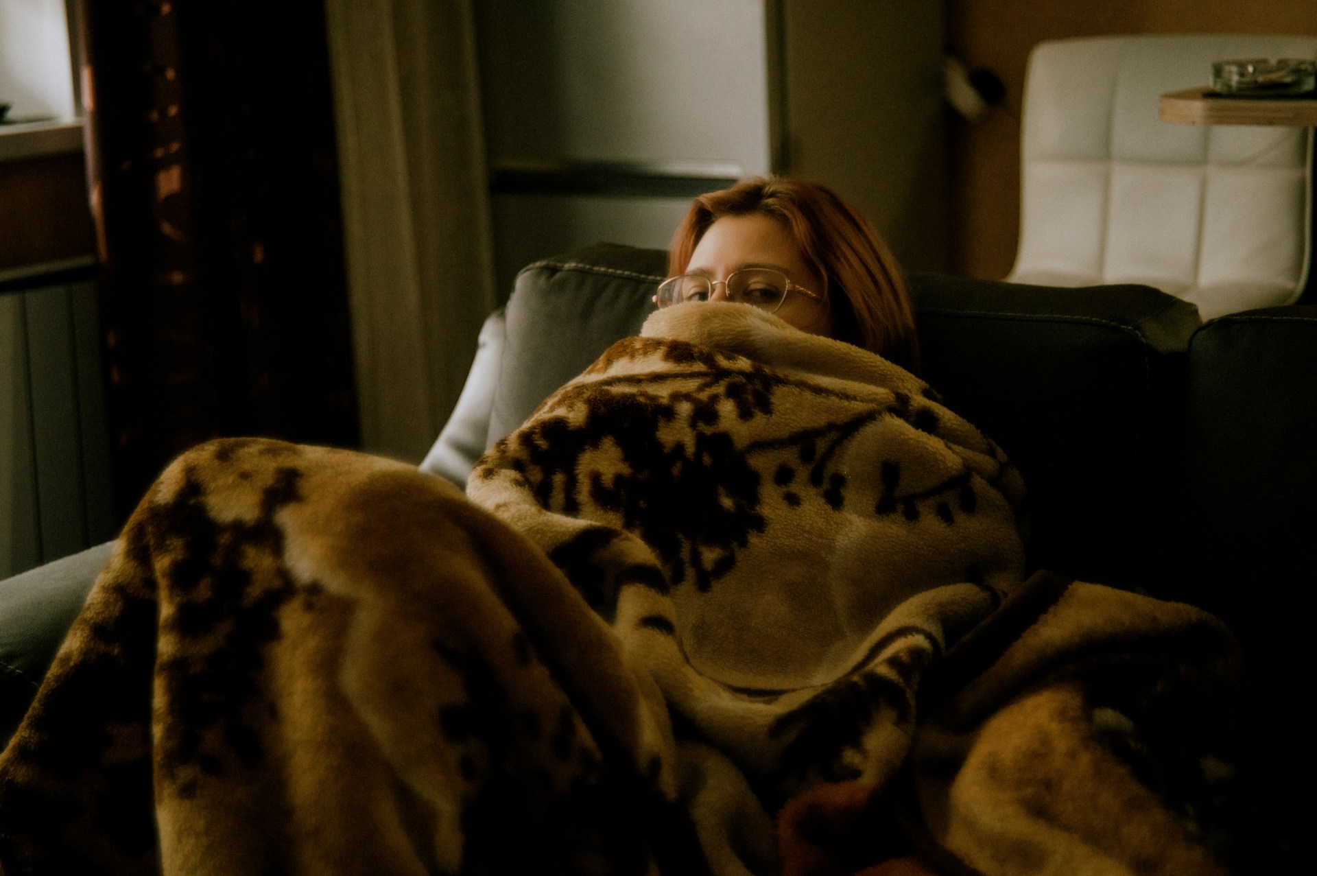 A woman in a white shirt lying on a bed.