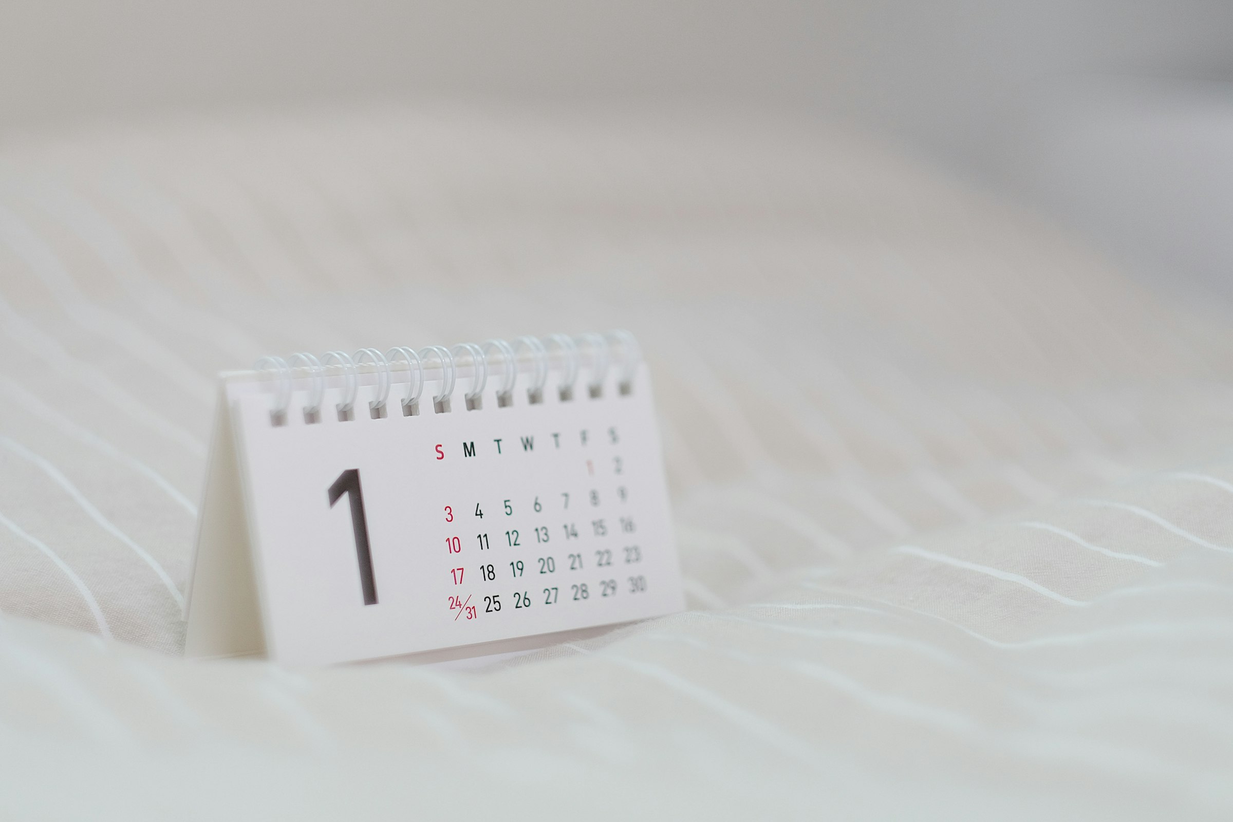 A calendar lying flat, representing a weekly weigh-in routine.